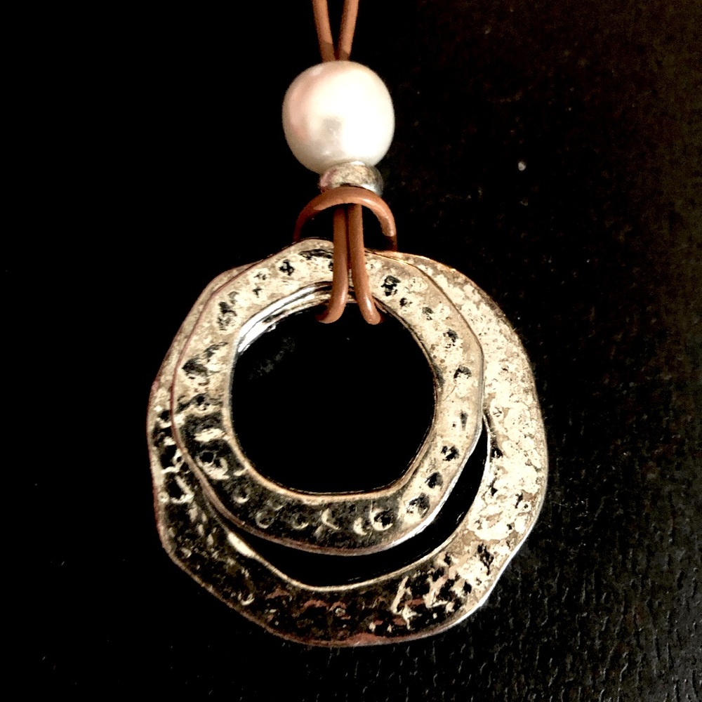Stylish silver circle pendant with long brown leather necklace